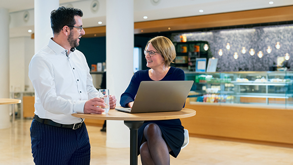 A man and a woman at a laptop