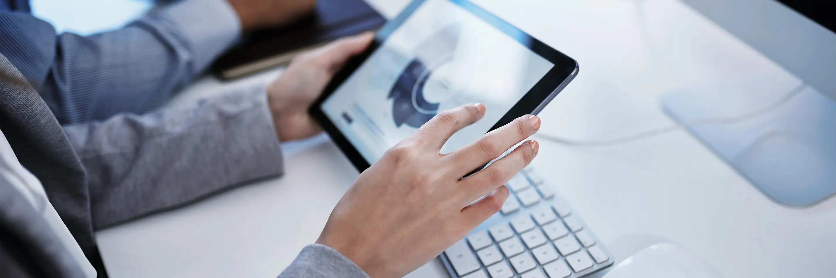 Hands tapping graphics on tablet