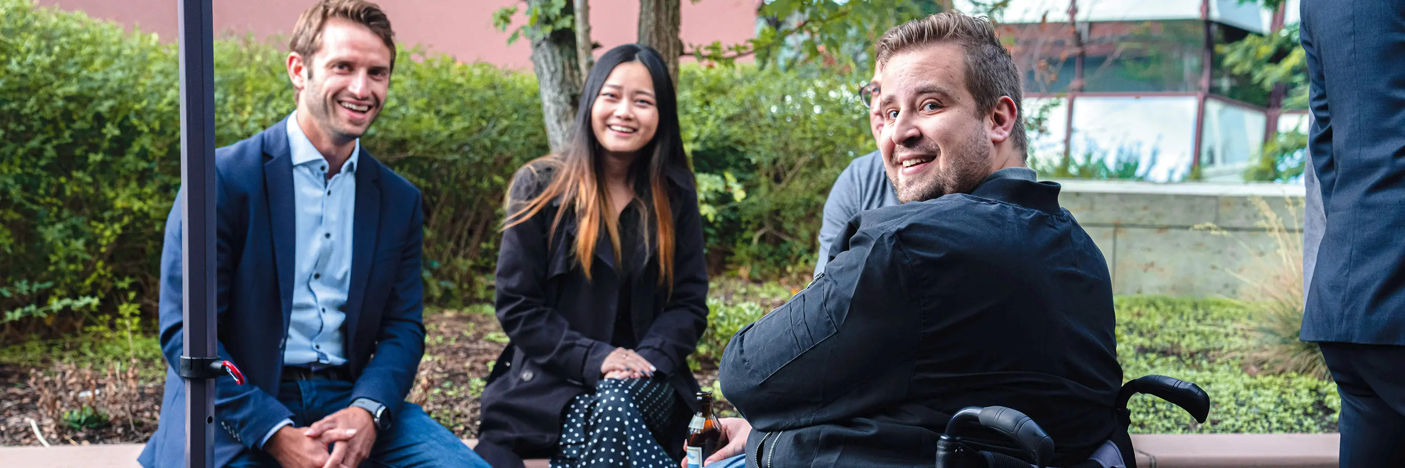 People sitting outside together smiling