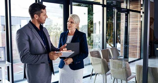 Two people talking in an office.