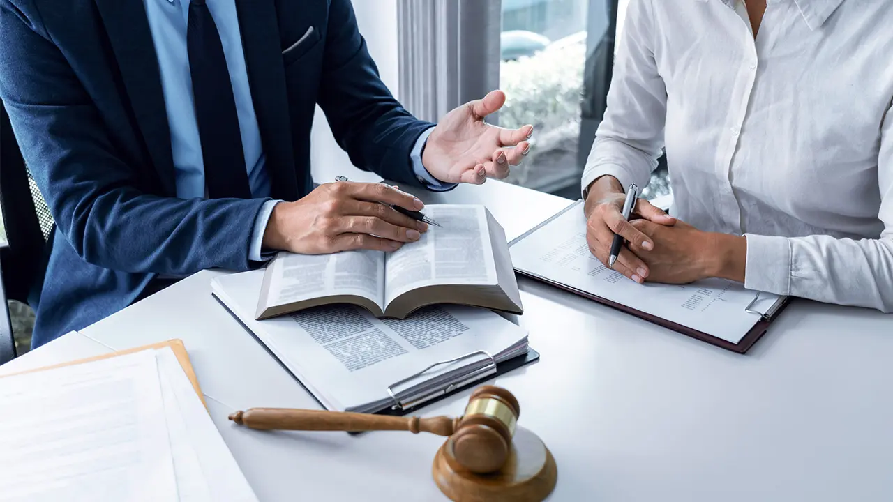 Two people discussing documents